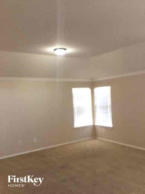 an empty living room with a light on the ceiling