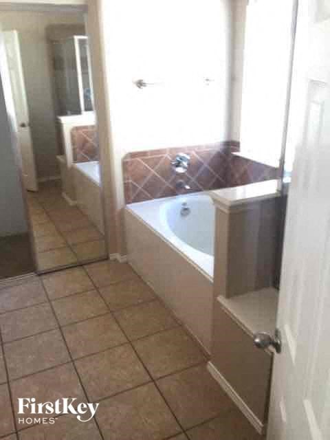 a bathroom with a bath tub and a window