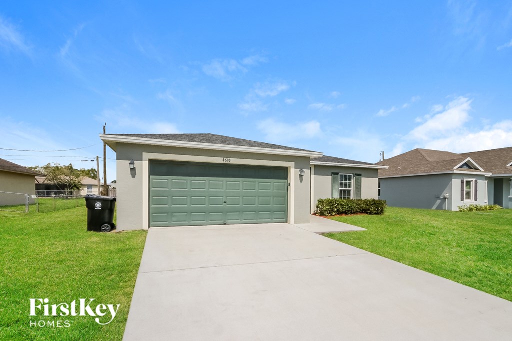a home with a garage door and a driveway