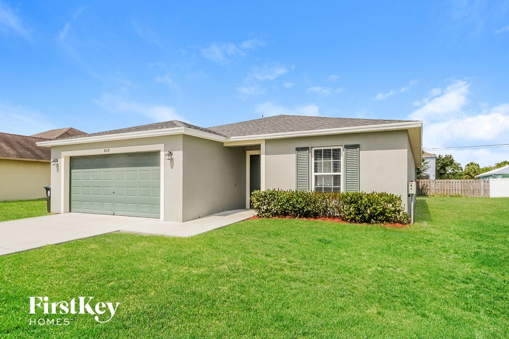 a home with a green lawn and a garage door