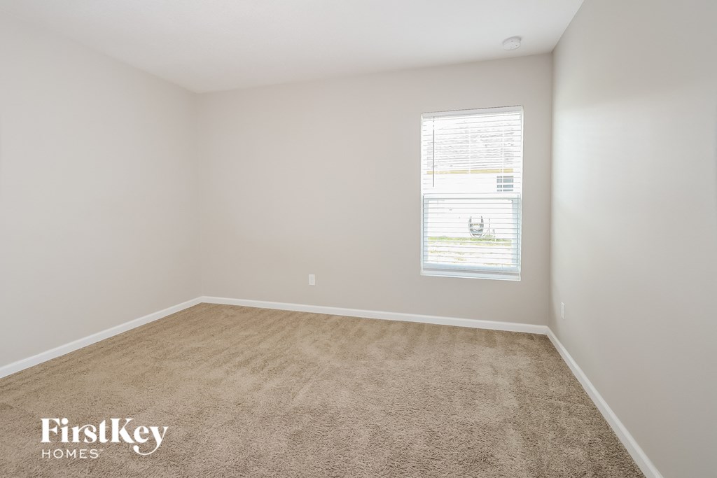a room with a carpeted floor and a window