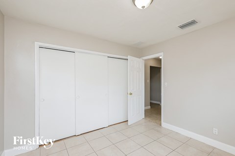a bedroom with two closets and a door to a hallway
