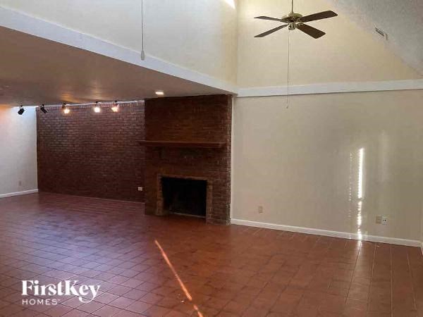 A room with a fireplace and a fan.