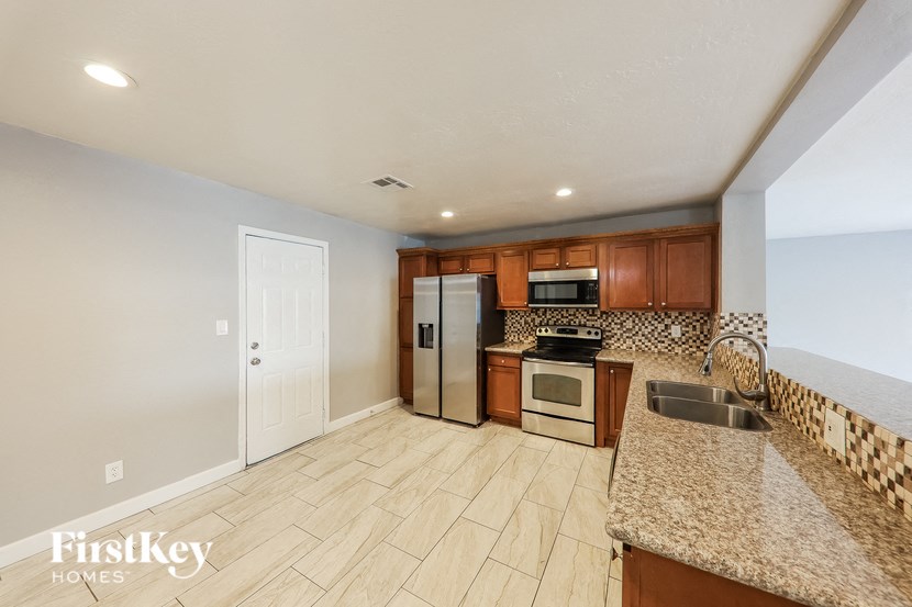 a kitchen with granite countertops and stainless steel appliances
