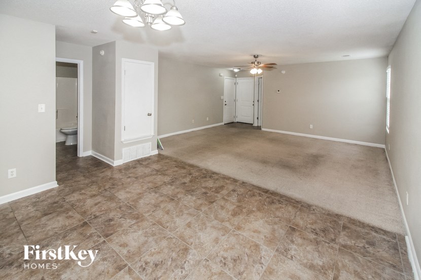 the living room and dining room of an empty house