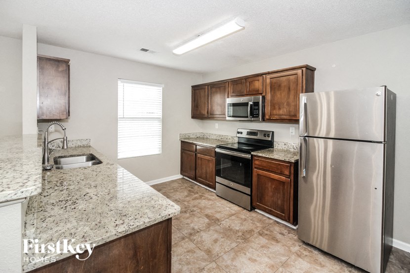 a kitchen with stainless steel appliances and granite counter tops
