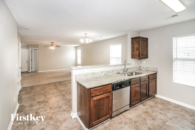 the kitchen is open to the living room and dining room