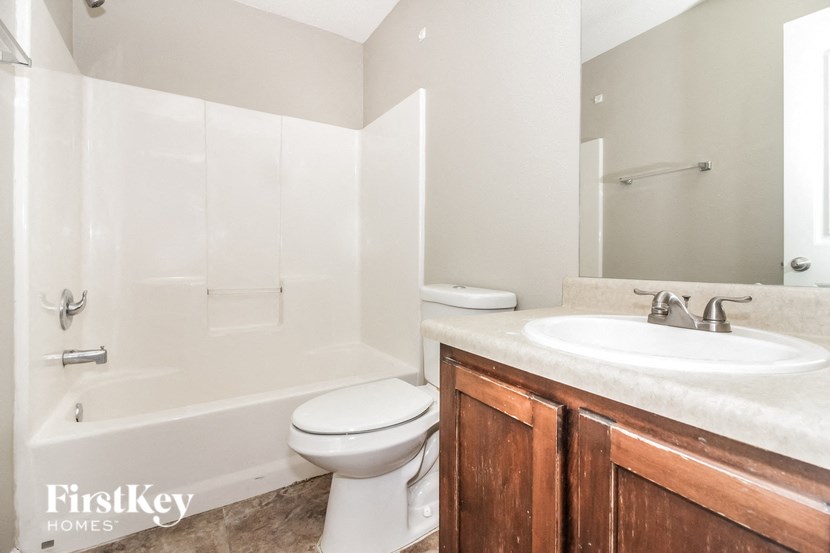 a bathroom with a sink toilet and a bath tub