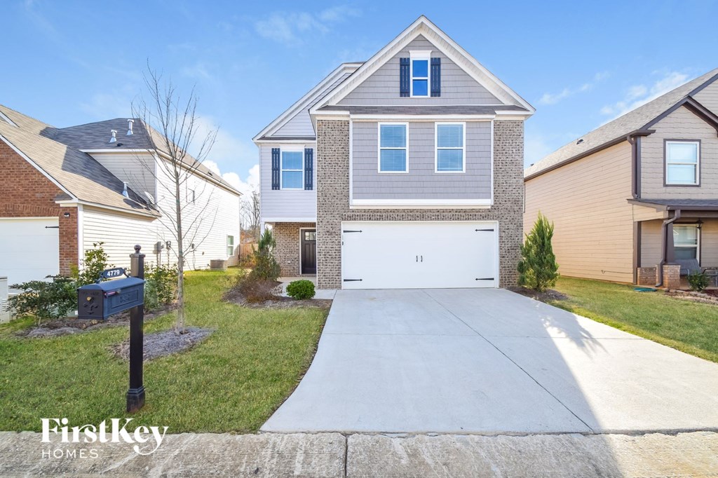 A house with a driveway in front of it.