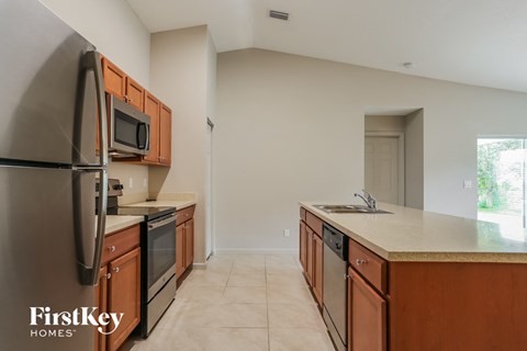 a kitchen with wooden cabinets and stainless steel appliances