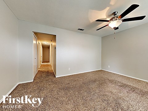 the master bedroom is spacious and has a ceiling fan