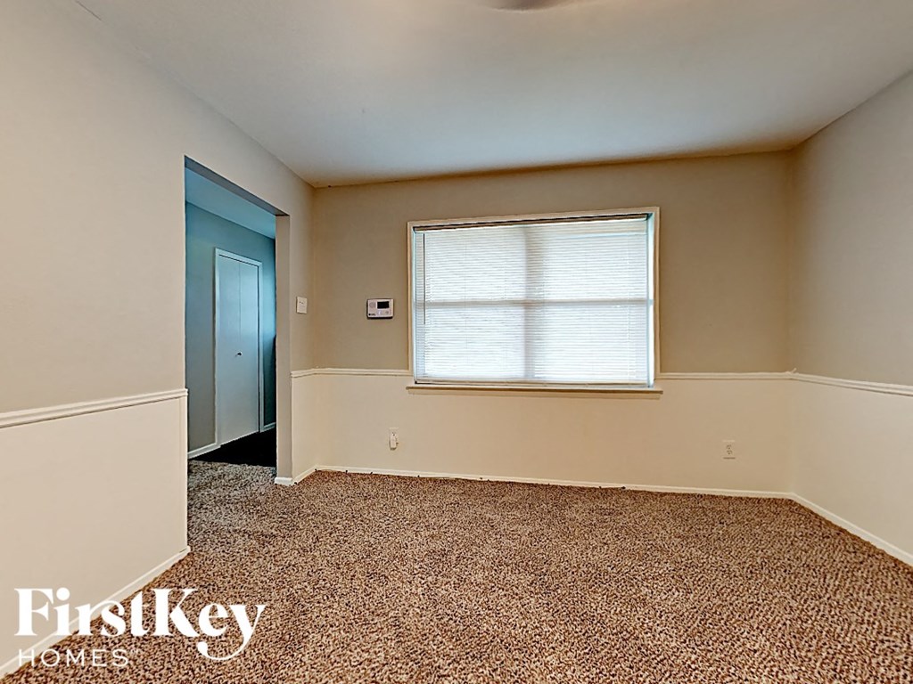 an empty room with a window and a door