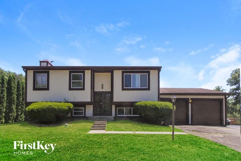 A two-story house with a garage is for sale.