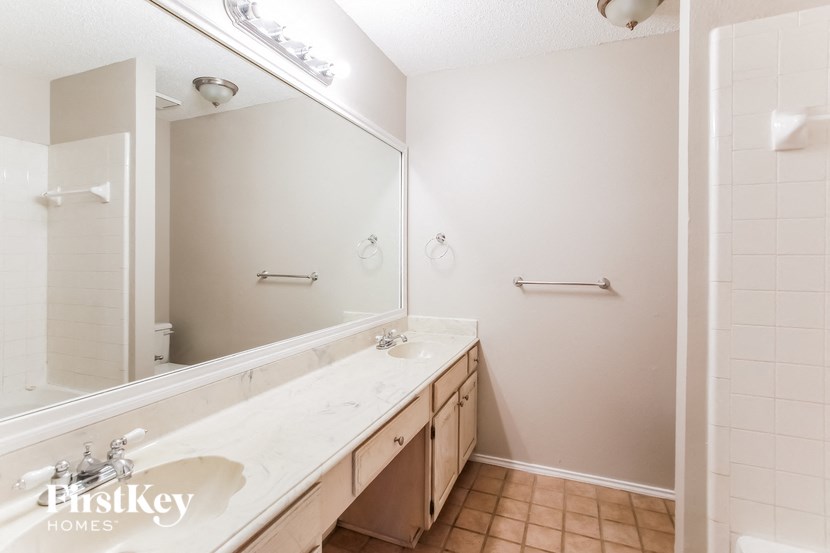 a bathroom with two sinks and a large mirror