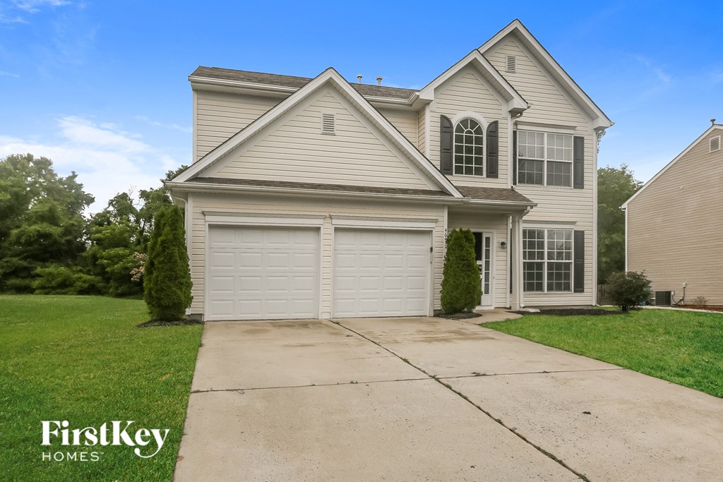 A two-story house with a garage is for sale by FirstKey Homes.