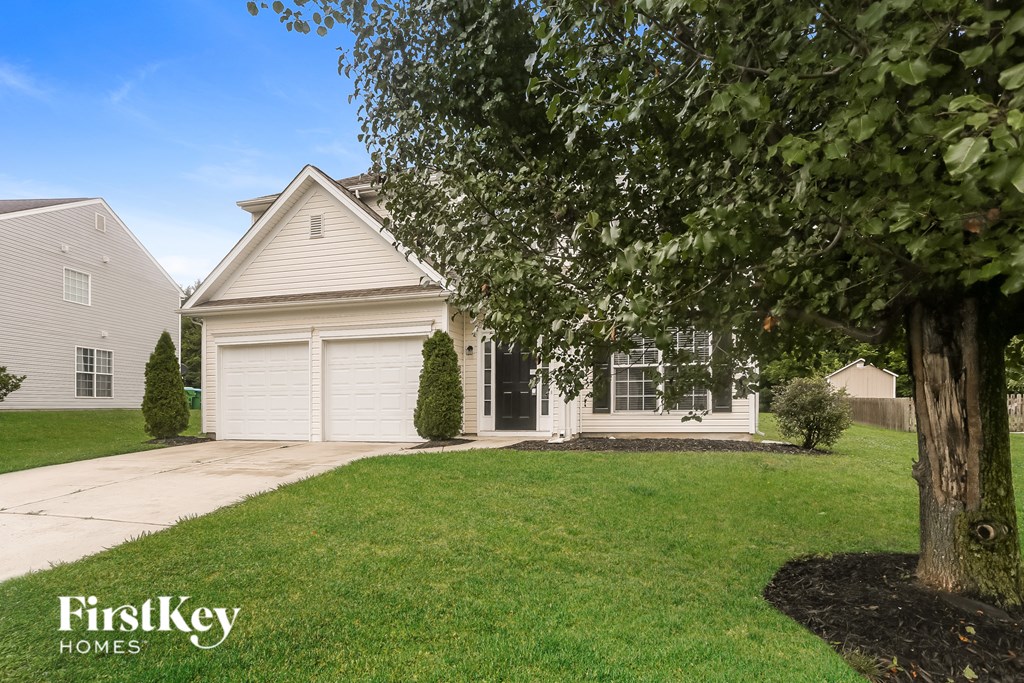 A house with a tree in front of it.
