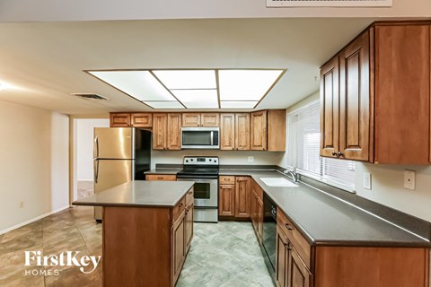 a kitchen with wooden cabinets and stainless steel appliances