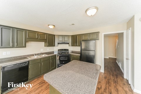 a kitchen with stainless steel appliances and granite counter tops