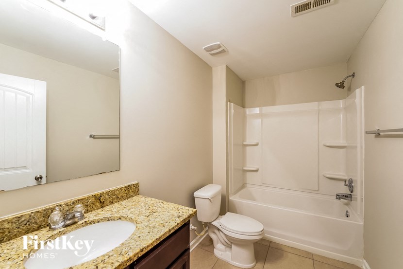 A bathroom with a sink, toilet and bathtub.