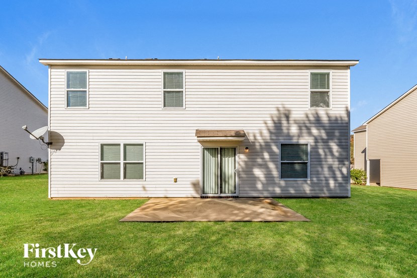 A two-story house with a brown door and windows.