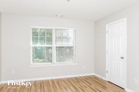 A room with a window and a door is shown.