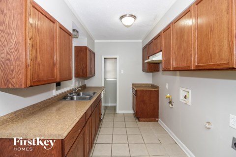 a kitchen with wooden cabinets and a sink and a counter top