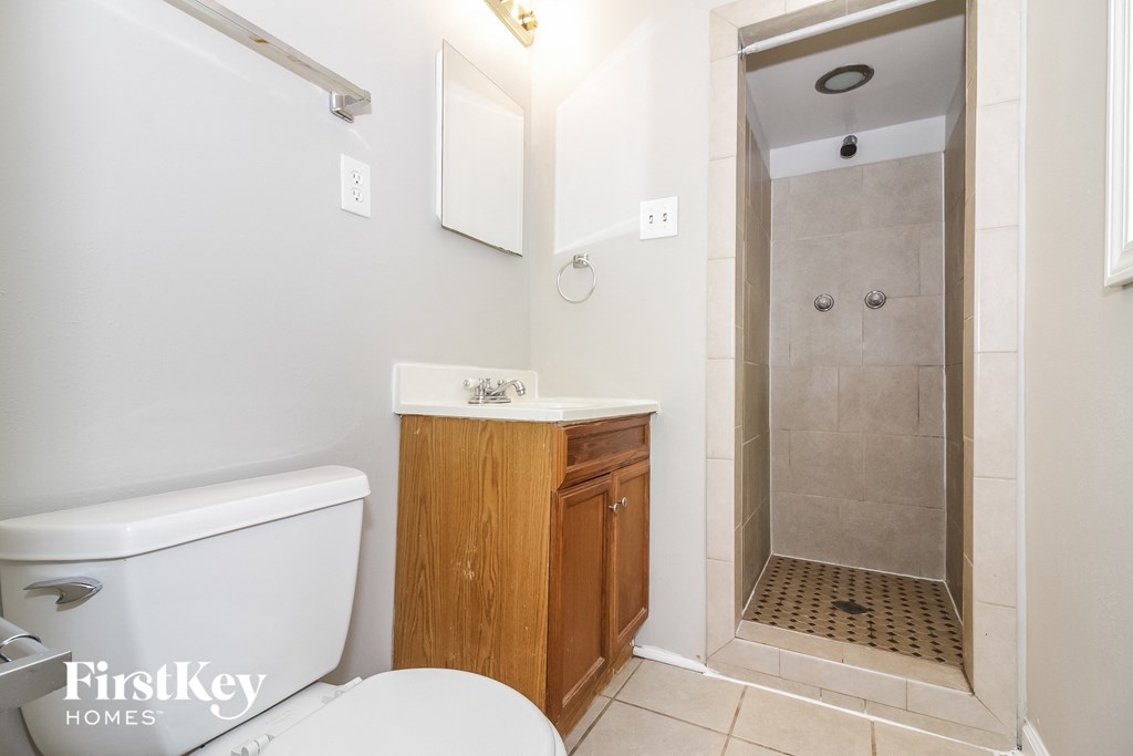 a small bathroom with a shower toilet and sink
