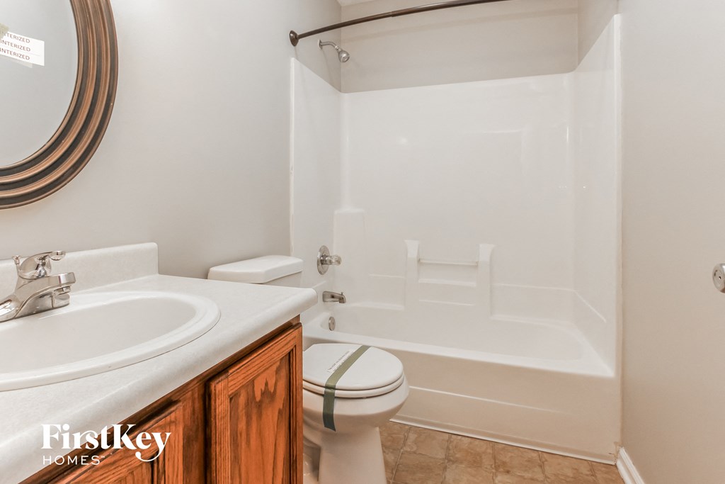 a bathroom with a sink toilet and a bath tub