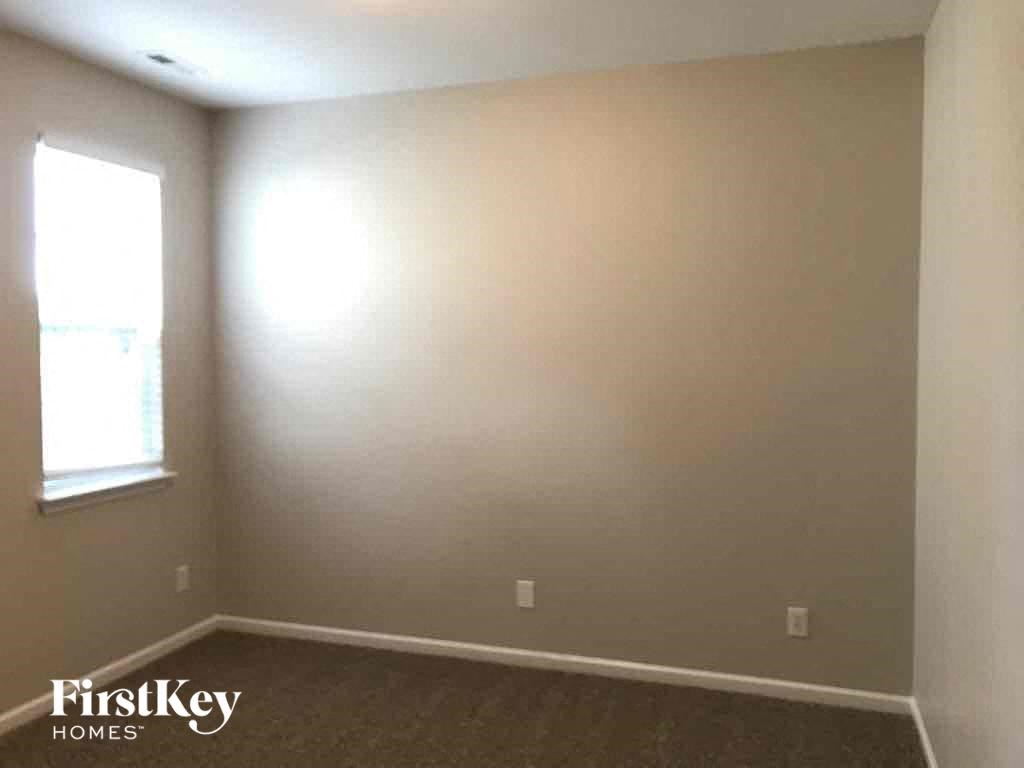 a empty room with a window and a carpet