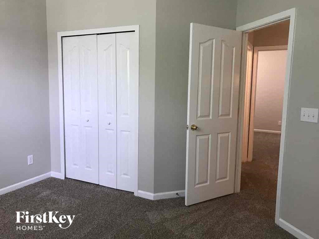 a room with two closets and a white door