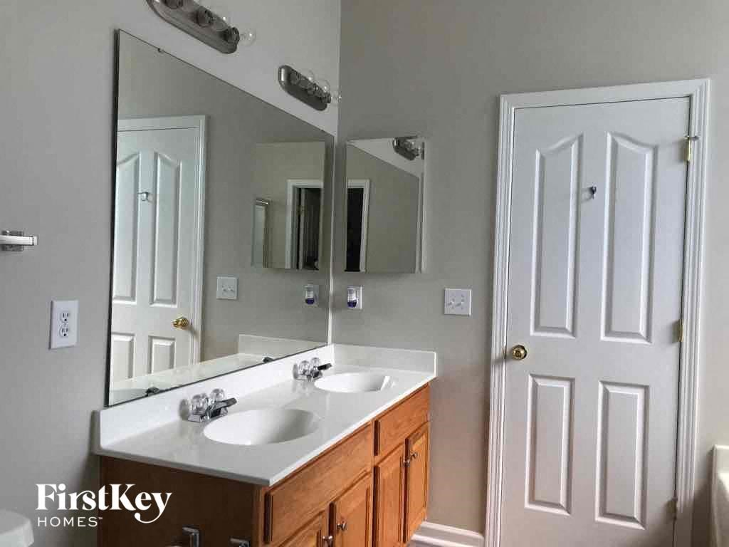 a bathroom with two sinks and a large mirror