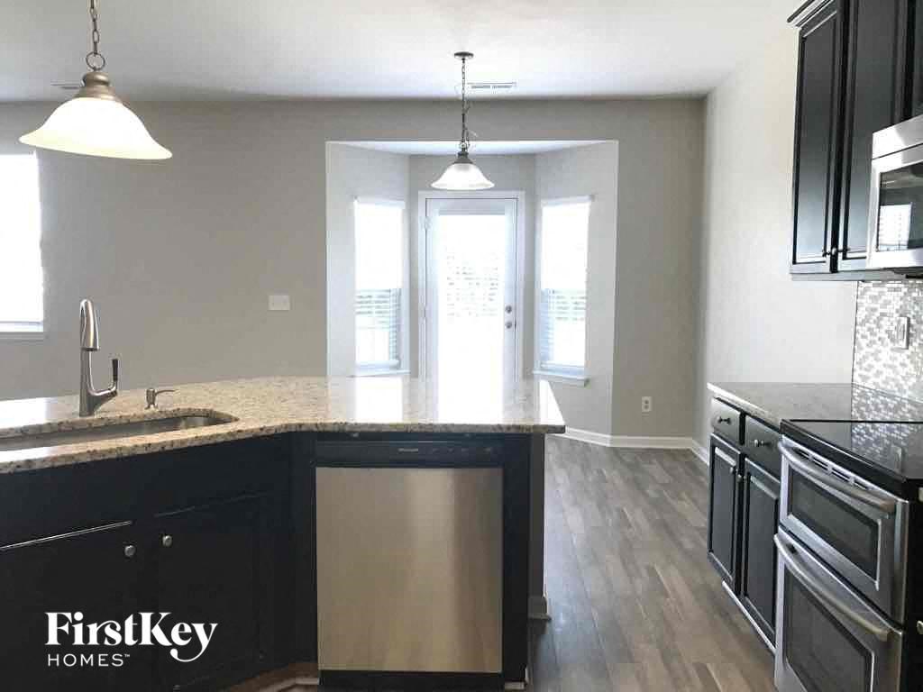 an empty kitchen with a sink and a counter top