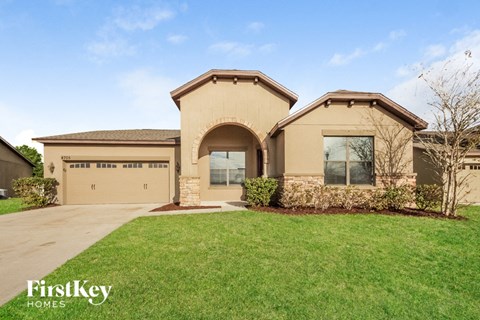 A house with a brown roof and a garage door that says "FirstKey Homes".