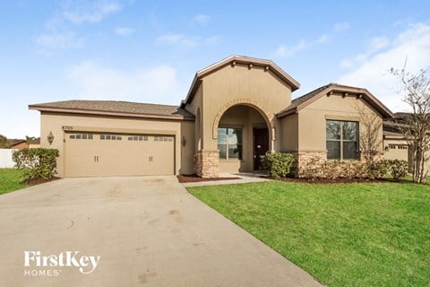 A house with a driveway in front of it.