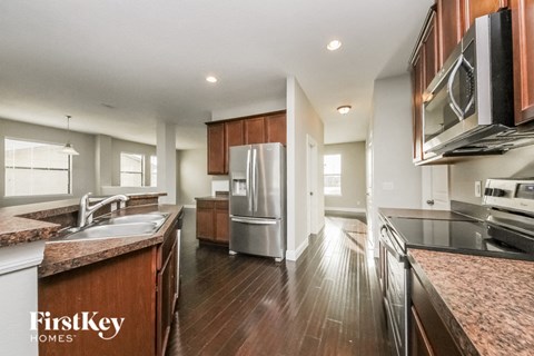A kitchen with wooden cabinets and a refrigerator.