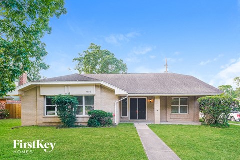 A house with a lawn in front of it.