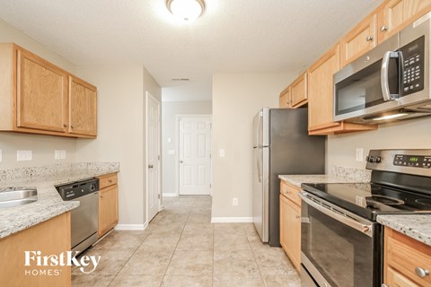 a kitchen with stainless steel appliances and wooden cabinets