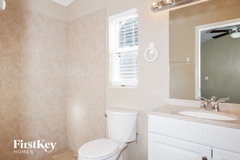 a bathroom with a toilet and a sink and a mirror