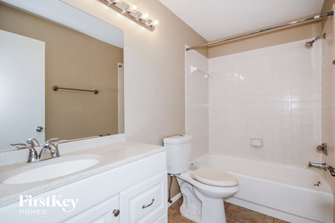 a bathroom with a sink toilet and a tub