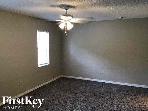 A room with a FirstKey Homes logo on the bottom left corner.