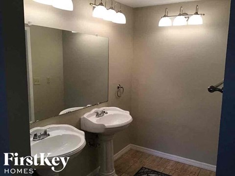 A bathroom with a sink and mirror.