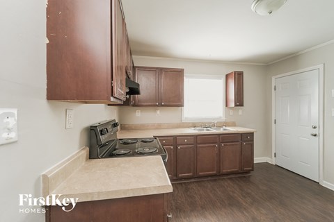A kitchen with brown cabinets and a beige countertop.
