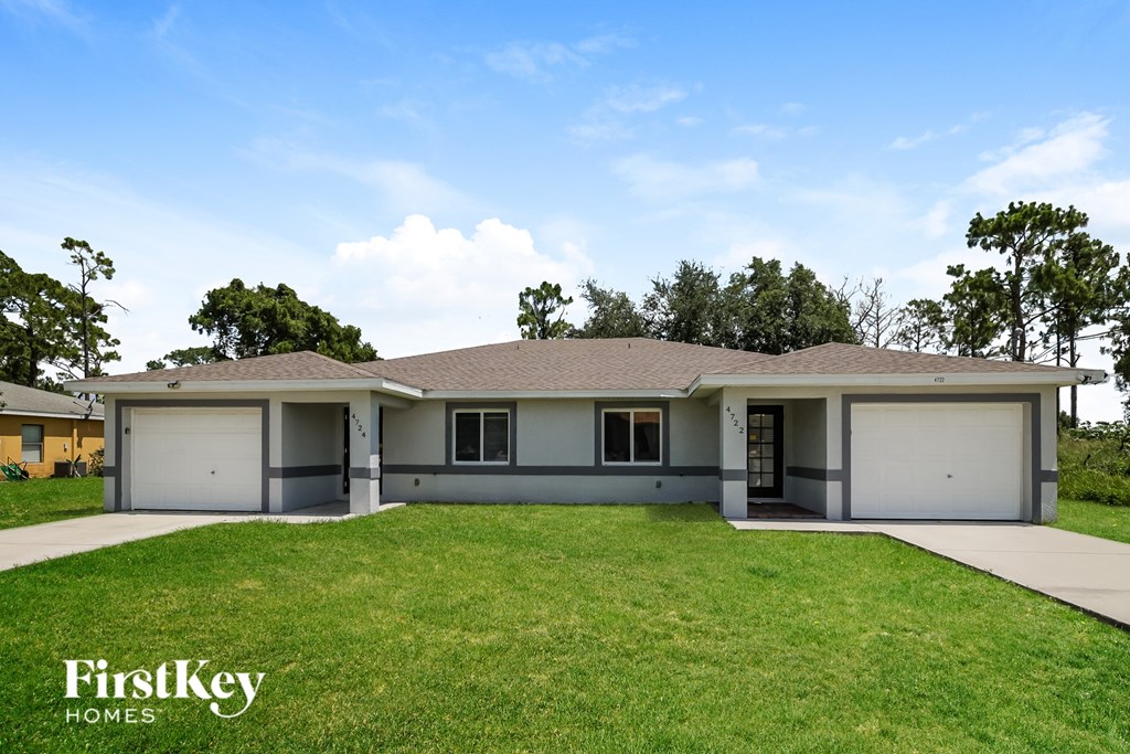A two-story house with a garage is for sale.