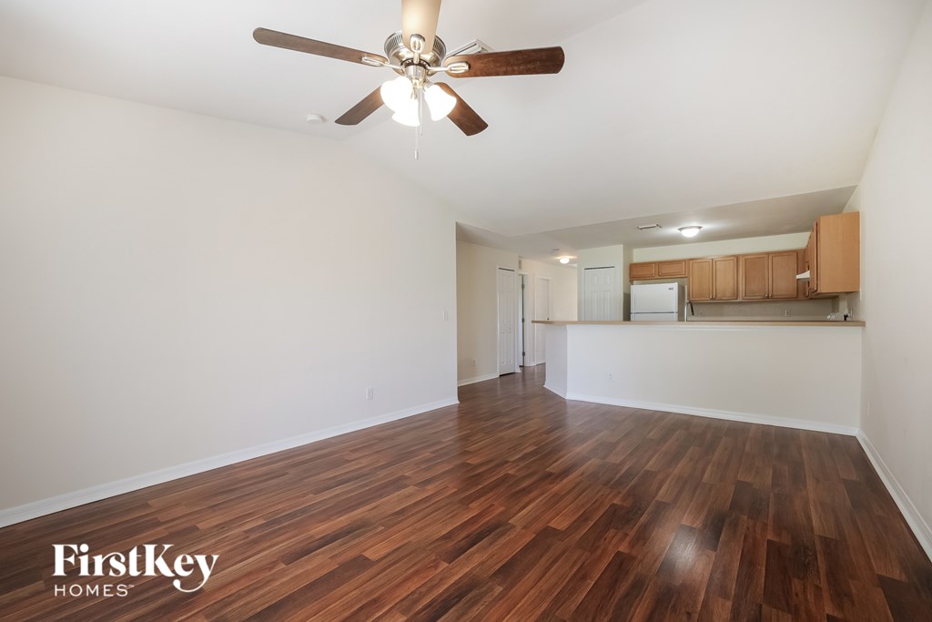 A room with wooden floors and a ceiling fan.