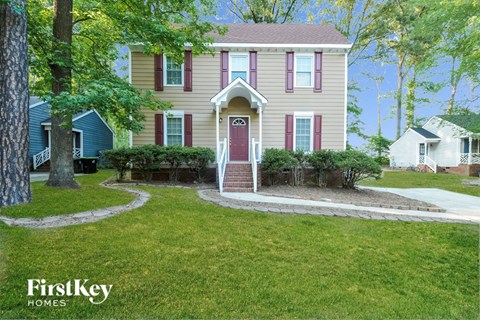A house with a red door and a small porch.