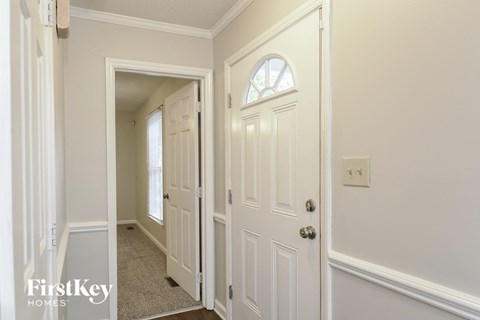 A white door with a window in the middle of it.