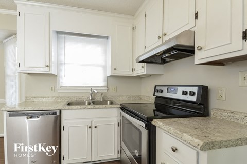 A kitchen with a stove top oven and a dishwasher.