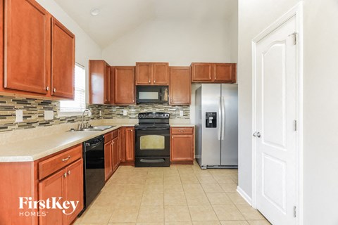 a large kitchen with wooden cabinets and stainless steel appliances
