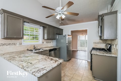a kitchen with stainless steel appliances and marble counter tops