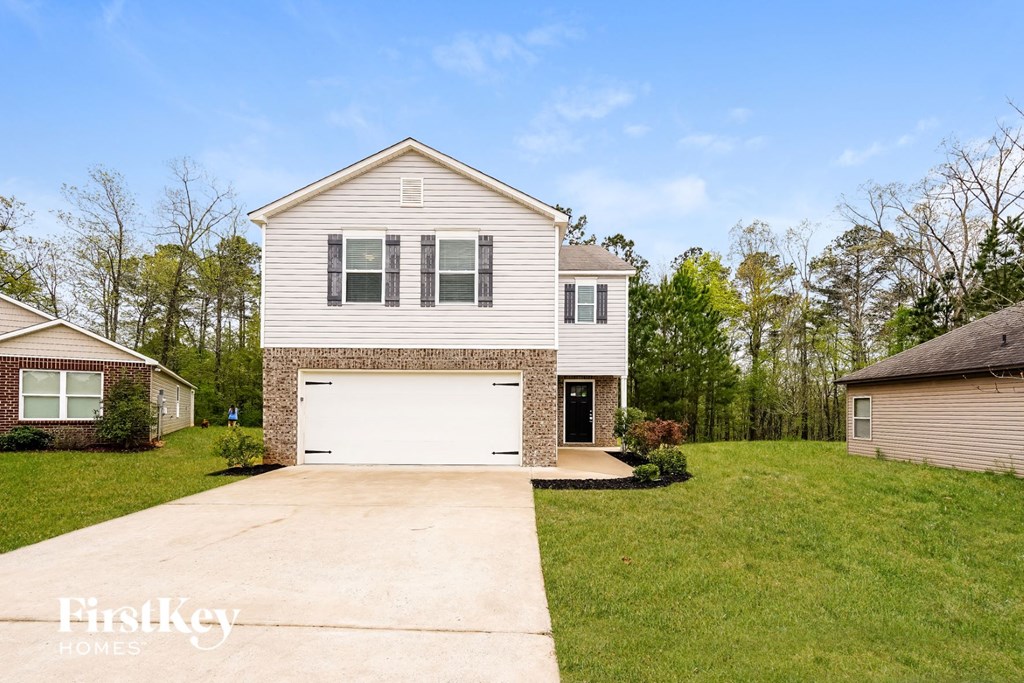 A two-story house with a garage is for sale.